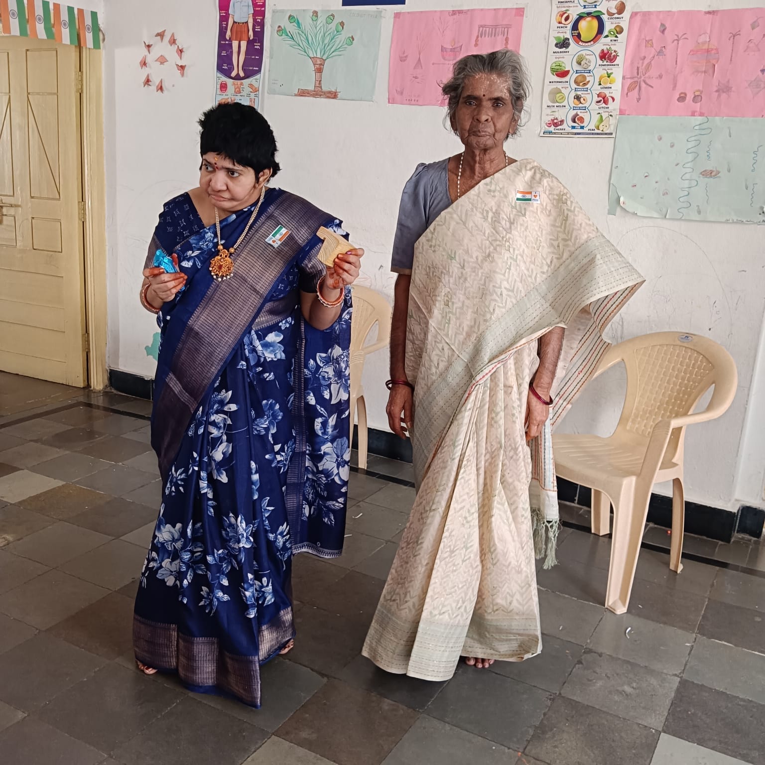 Trustee greeting a beneficiary with sweets during Independence Day celebrations at the special school